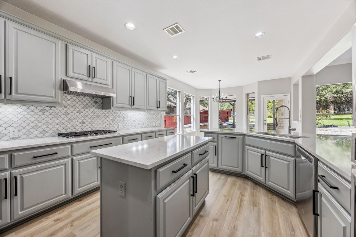 308 Calistoga Court Austin, TX 78732 - Photo 24 of 40 a kitchen with granite countertop cabinets stainless steel appliances and a counter space
