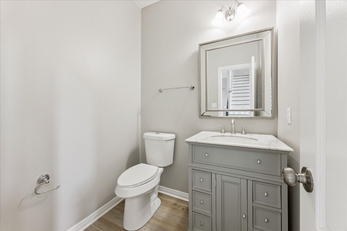 308 Calistoga Court Austin, TX 78732 - Photo 25 of 40 a bathroom with a toilet sink and mirror