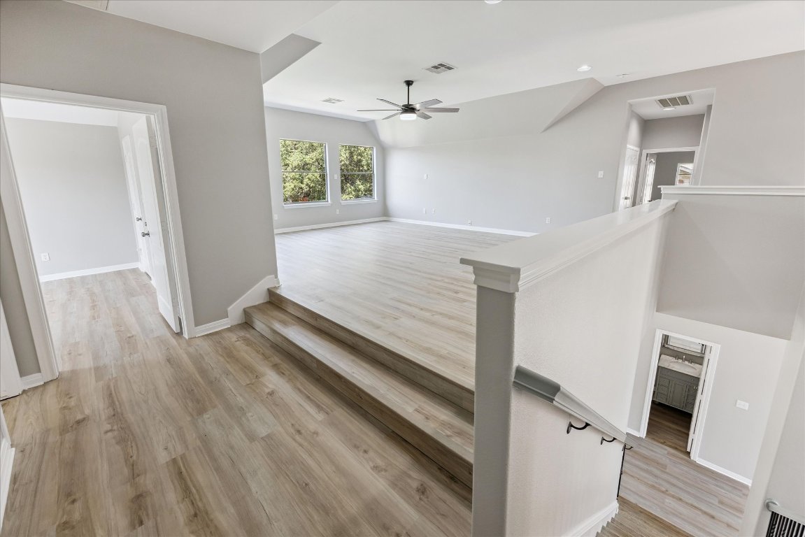 308 Calistoga Court Austin, TX 78732 - Photo 30 of 40 a view of a hallway with wooden floor and staircase