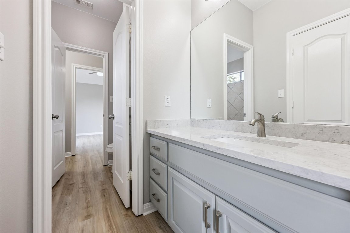 308 Calistoga Court Austin, TX 78732 - Photo 33 of 40 a en suite bathroom with a granite countertop sink