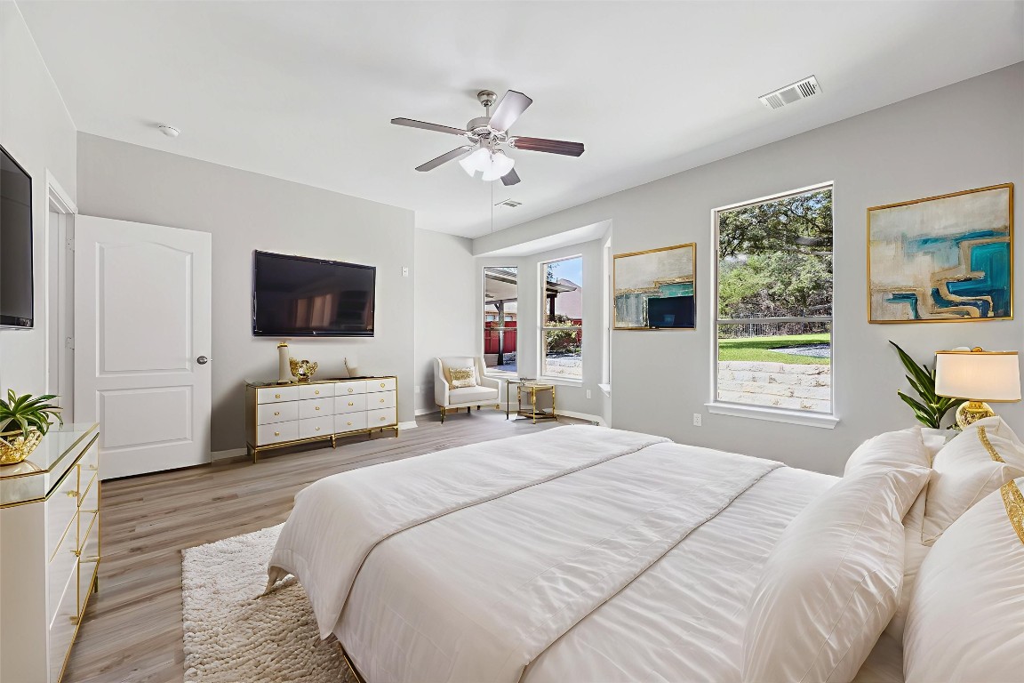 308 Calistoga Court Austin, TX 78732 - Photo 6 of 40 a bedroom with a bed and a flat screen tv