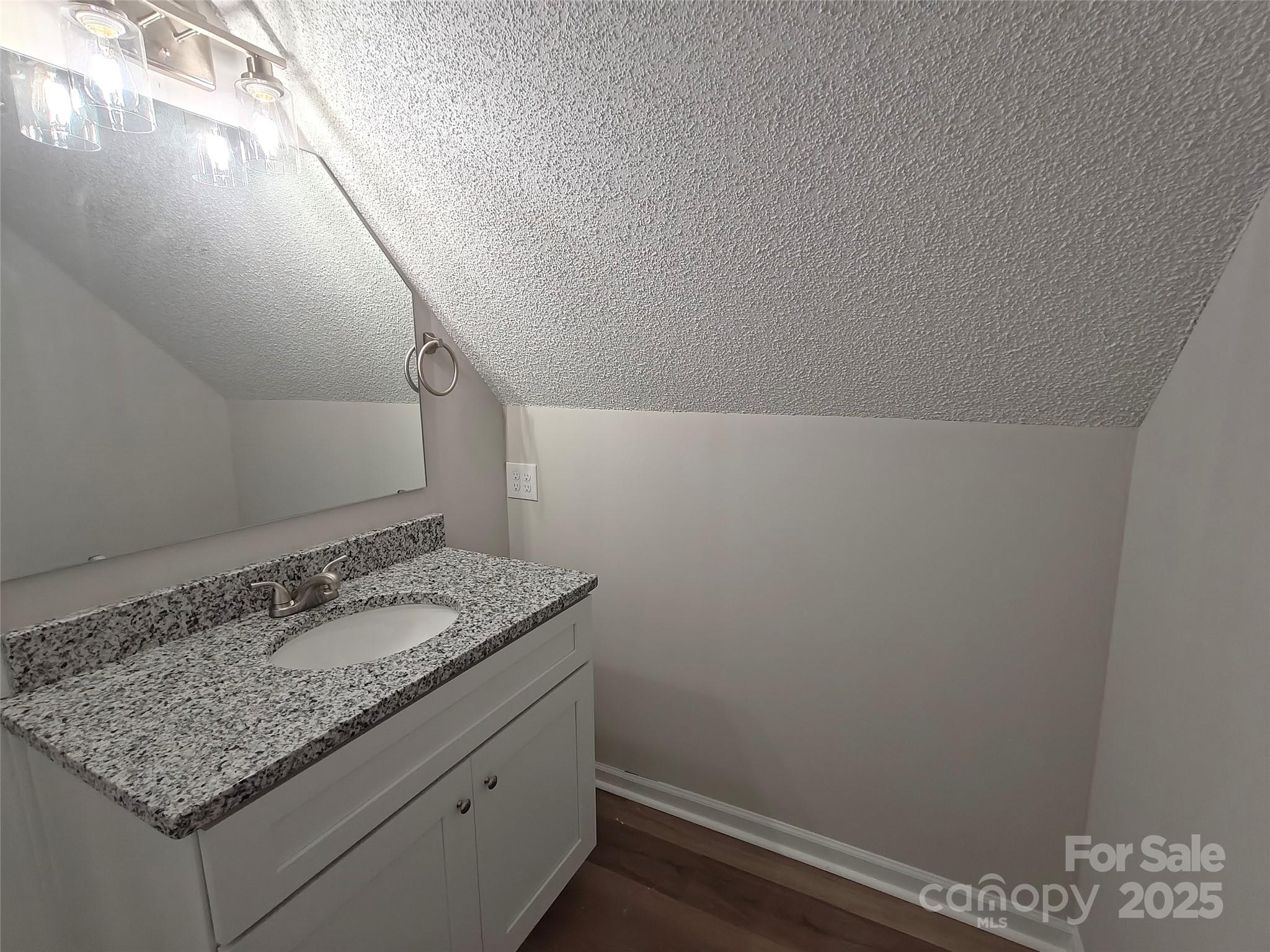 406 4th Street Spencer, NC 28159 - Photo 11 of 16 a bathroom with a granite countertop sink and vanity