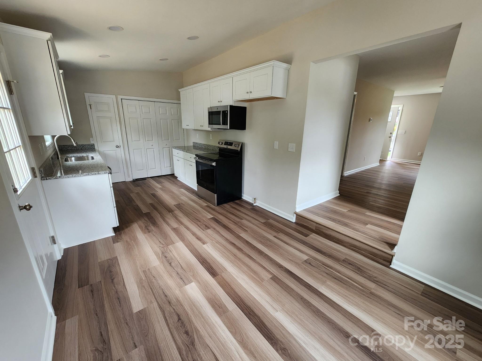 406 4th Street Spencer, NC 28159 - Photo 6 of 16 a view of kitchen with sink microwave and refrigerator