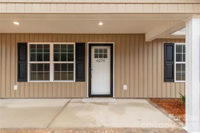 a view of a house with a parking space
