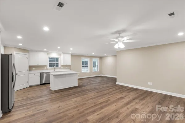 a view of kitchen with cabinets and wooden floor