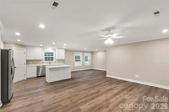 a view of kitchen with cabinets and wooden floor
