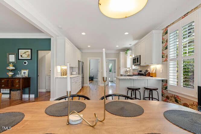 3012 Shenandoah Avenue Durham, NC 27704 - Photo 13 of 50 a kitchen with sink refrigerator and couches with wooden floor