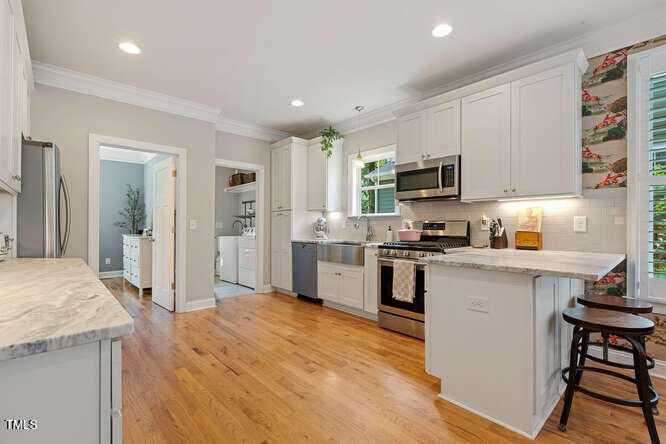 3012 Shenandoah Avenue Durham, NC 27704 - Photo 18 of 50 a kitchen with granite countertop a refrigerator stove top oven and sink