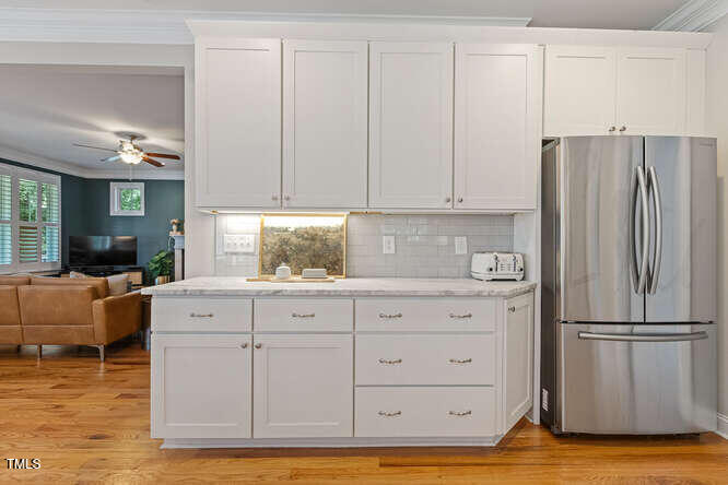 3012 Shenandoah Avenue Durham, NC 27704 - Photo 20 of 50 a kitchen with granite countertop a refrigerator and cabinets
