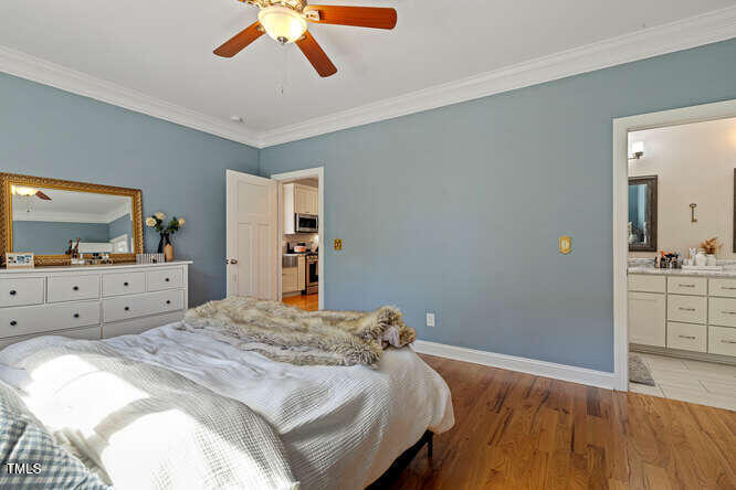 3012 Shenandoah Avenue Durham, NC 27704 - Photo 27 of 50 a bedroom with a large bed and a flat tv screen on dresser