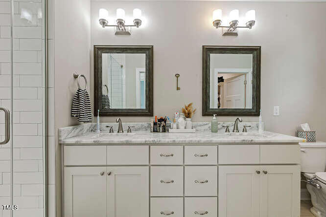3012 Shenandoah Avenue Durham, NC 27704 - Photo 28 of 50 a bathroom with a double vanity sink and a mirror