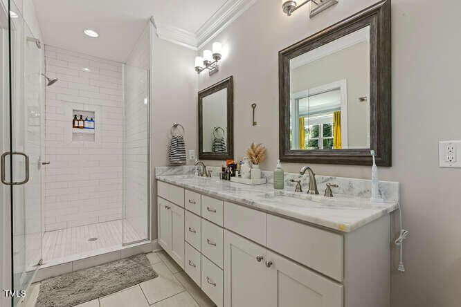 3012 Shenandoah Avenue Durham, NC 27704 - Photo 29 of 50 a bathroom with a double vanity sink mirror and shower