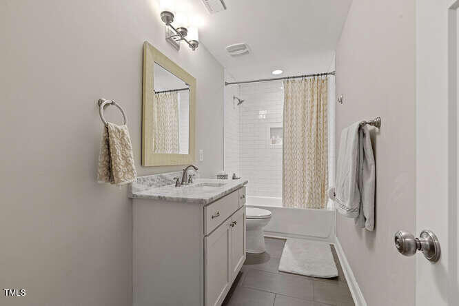 3012 Shenandoah Avenue Durham, NC 27704 - Photo 35 of 50 a bathroom with a double vanity sink a toilet and a mirror