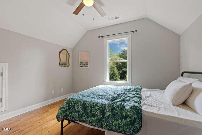 3012 Shenandoah Avenue Durham, NC 27704 - Photo 36 of 50 a bedroom with a bed window and a wooden floor