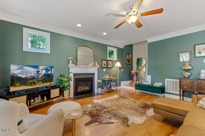 3012 Shenandoah Avenue Durham, NC 27704 - Photo 6 of 50 a living room with furniture a flat screen tv and a fireplace