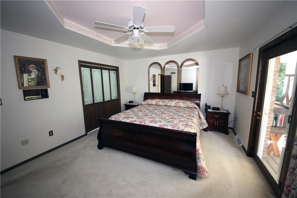 134 Quarry Road Latrobe, PA 15650 - Photo 14 of 25 Spacious master bedroom with tray ceiling and ceiling fan, french door to the right leads to trex deck. To the left, notice the decorative double doors to master bath.