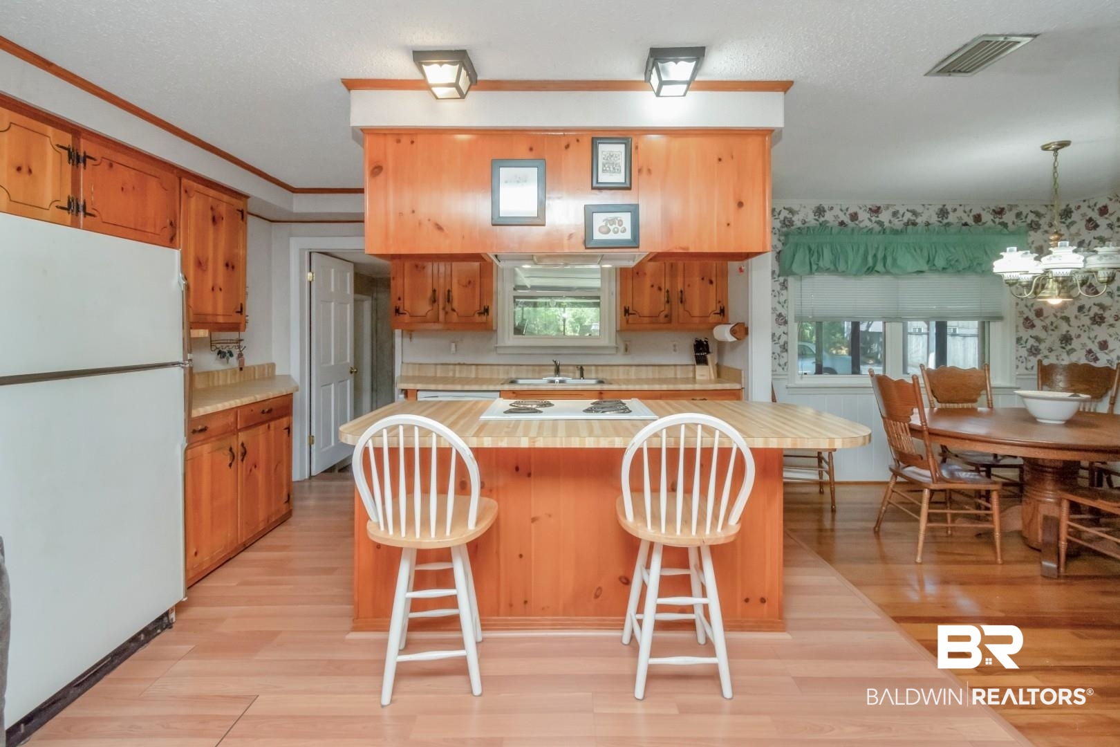 6300 Woodcrest Drive Mobile, AL 36608 - Photo 11 of 35 Kitchen featuring light wood-style floors, light countertops, white appliances, and visible vents