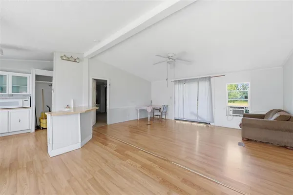 a big room with wooden floor and windows
