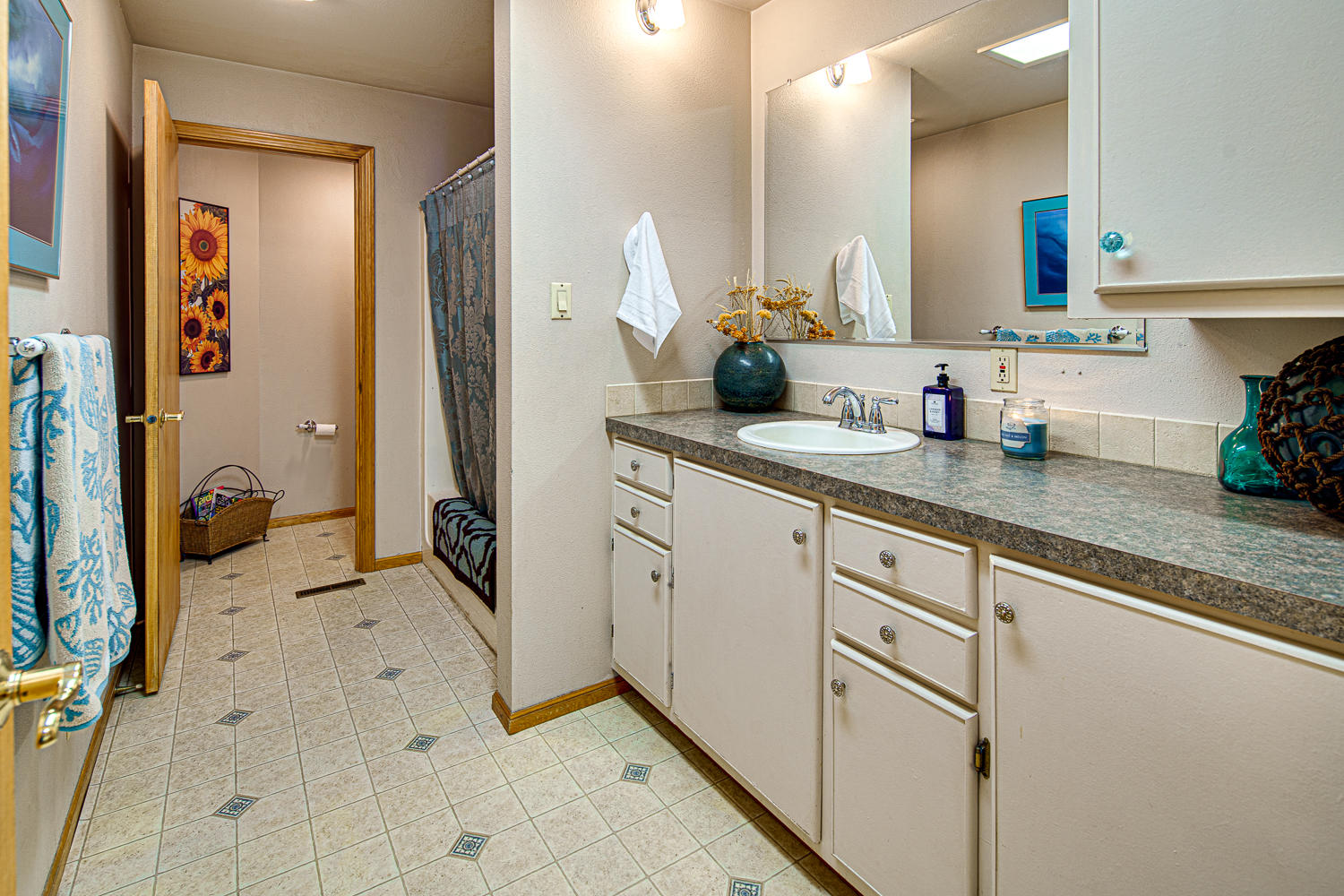 22145 Neff Road Bend, OR 97701 - Photo 29 of 50 a spacious bathroom with a granite countertop sink and a mirror