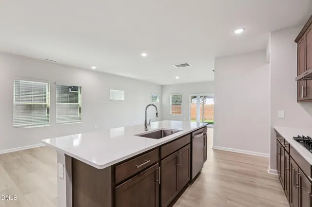 a kitchen with sink cabinets and wooden floor