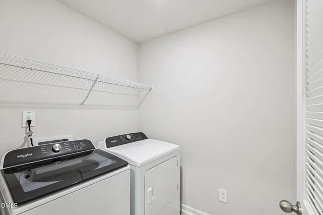 a bathroom with a double vanity sink toilet and mirror