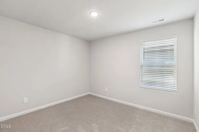 a view of an empty room and closet area