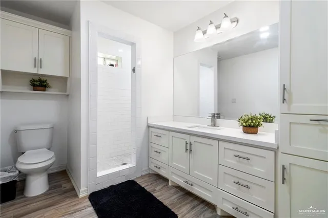 a bathroom with a double vanity sink and a toilet