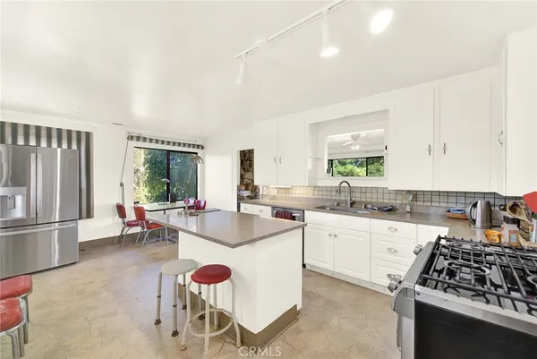 a kitchen with a sink stove and cabinets
