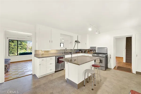 a kitchen with a sink stove and cabinets