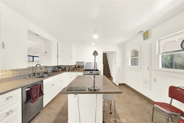 a kitchen with a sink stove and cabinets