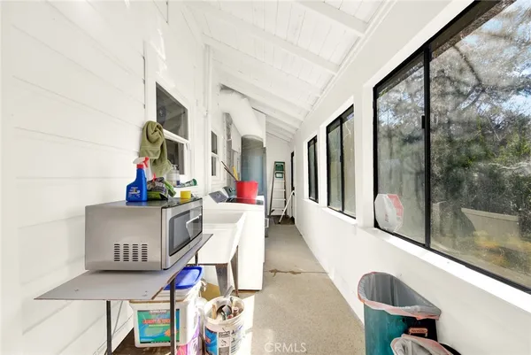 a living room with furniture and a floor to ceiling window