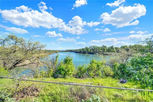 a view of a lake with a yard