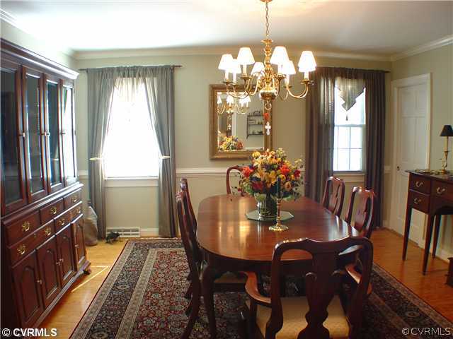 13901 Elmstead Road Midlothian, VA 23113 - Photo 3 of 12 a dining room with furniture a chandelier and wooden floor