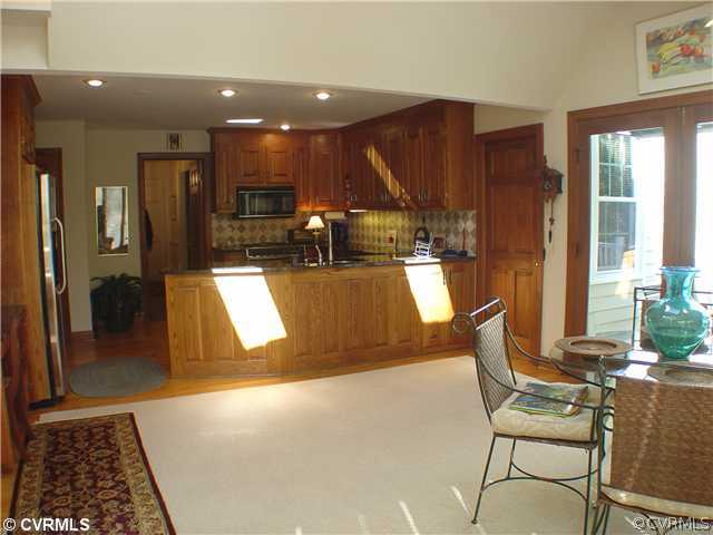 13901 Elmstead Road Midlothian, VA 23113 - Photo 7 of 12 a view of a living room and kitchen with furniture and a rug