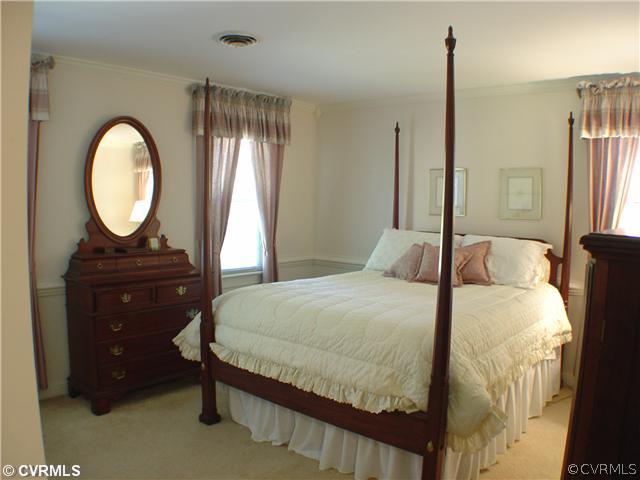 13901 Elmstead Road Midlothian, VA 23113 - Photo 9 of 12 a bedroom with a bed and a mirror on dresser