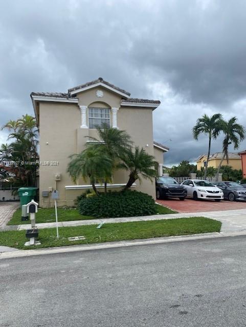 9475 Southwest 154th Court Miami, FL 33196 - Photo 2 of 27 a front view of a house with a yard and garage