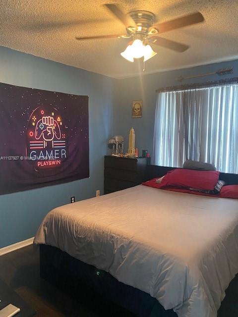 9475 Southwest 154th Court Miami, FL 33196 - Photo 12 of 27 a bedroom with a bed and a chandelier