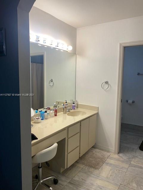 9475 Southwest 154th Court Miami, FL 33196 - Photo 17 of 27 a bathroom with a double vanity sink mirror and shower