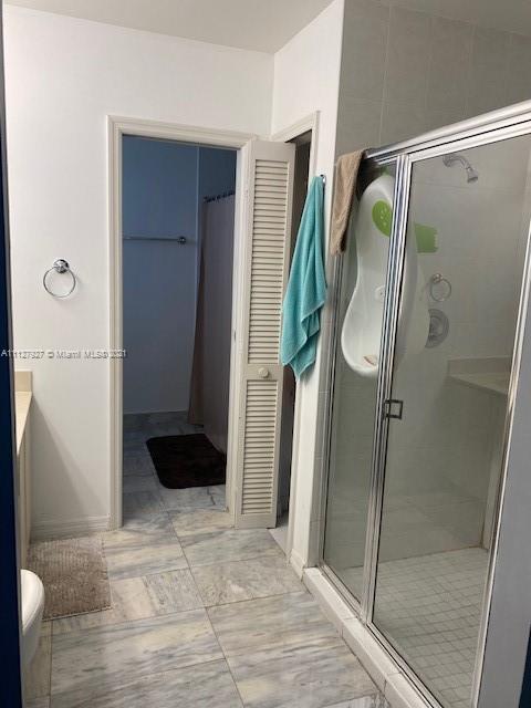 9475 Southwest 154th Court Miami, FL 33196 - Photo 18 of 27 a bathroom with a glass shower door