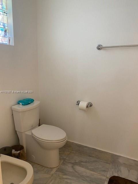 9475 Southwest 154th Court Miami, FL 33196 - Photo 19 of 27 a white toilet sitting next to a bathroom sink