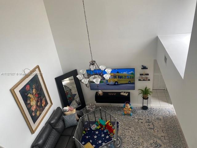 9475 Southwest 154th Court Miami, FL 33196 - Photo 20 of 27 a living room with furniture stairs and a chandelier