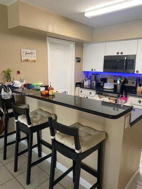 9475 Southwest 154th Court Miami, FL 33196 - Photo 3 of 27 a kitchen with a table chairs stove and cabinets