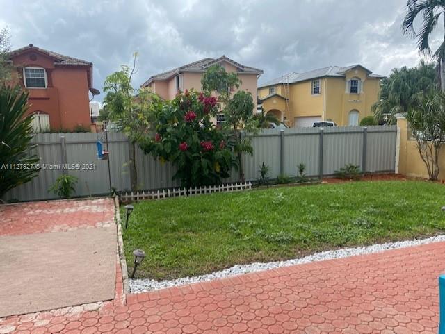 9475 Southwest 154th Court Miami, FL 33196 - Photo 23 of 27 a view of backyard with potted plants and a wooden fence