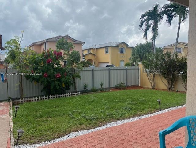 9475 Southwest 154th Court Miami, FL 33196 - Photo 25 of 27 front view of house with a yard and palm trees