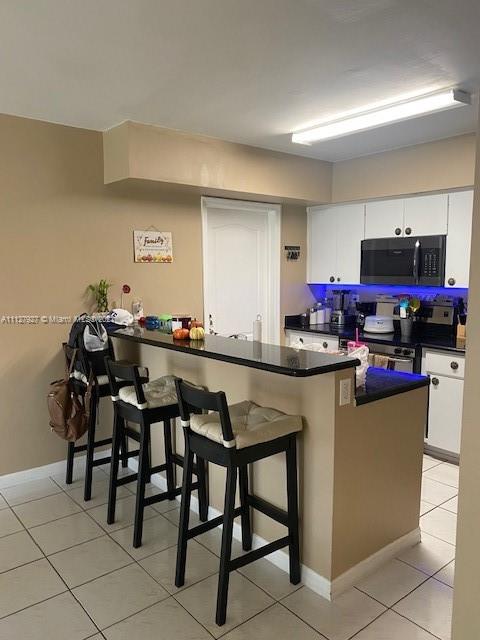 9475 Southwest 154th Court Miami, FL 33196 - Photo 7 of 27 a kitchen with stainless steel appliances granite countertop a table chairs and a refrigerator