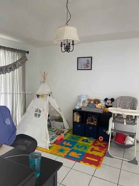 9475 Southwest 154th Court Miami, FL 33196 - Photo 8 of 27 a bedroom with furniture and a wooden floor
