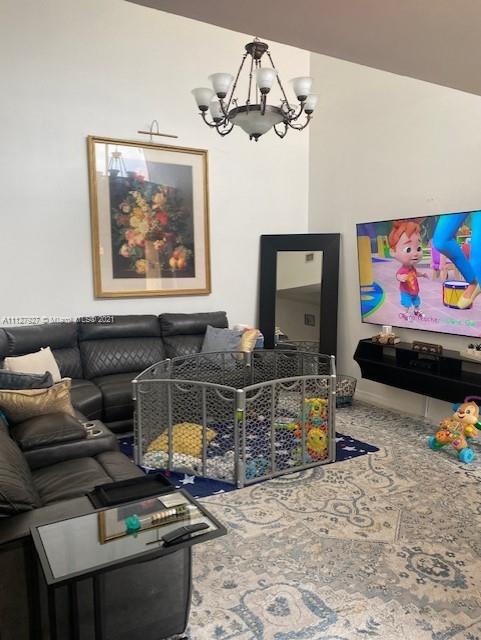 9475 Southwest 154th Court Miami, FL 33196 - Photo 9 of 27 a living room with furniture and a flat screen tv
