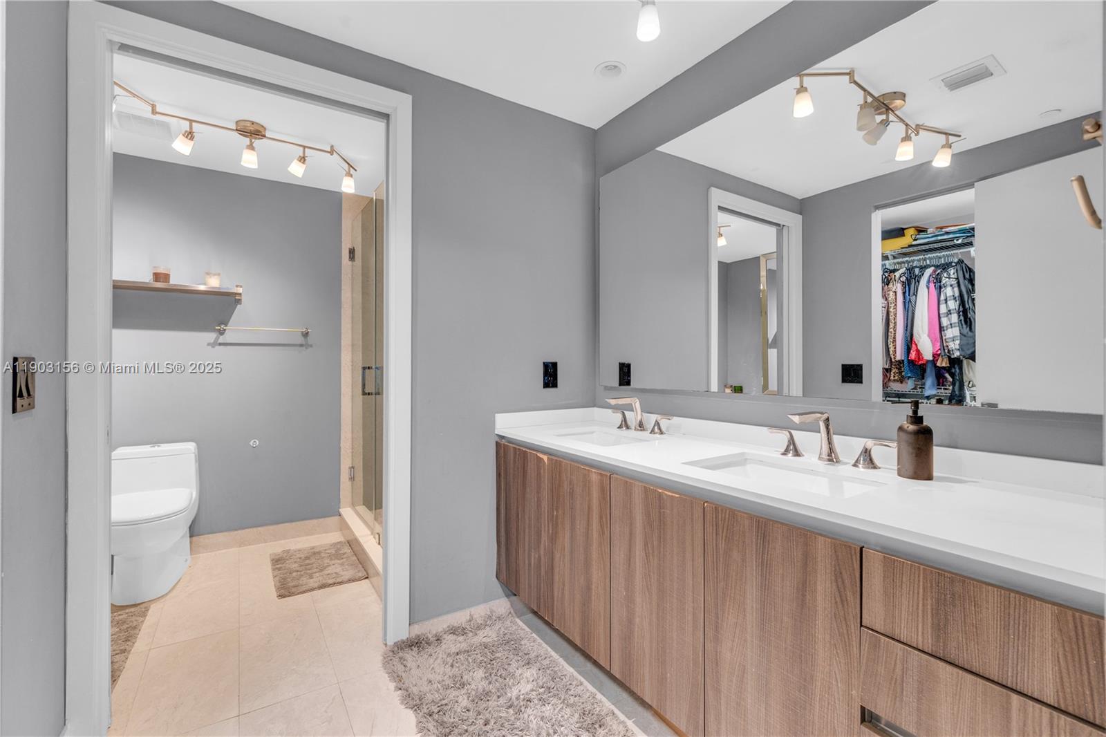 488 Northeast 18th Street, Unit 2104 Miami, FL 33132 - Photo 14 of 44 a bathroom with a double vanity sink and a mirror