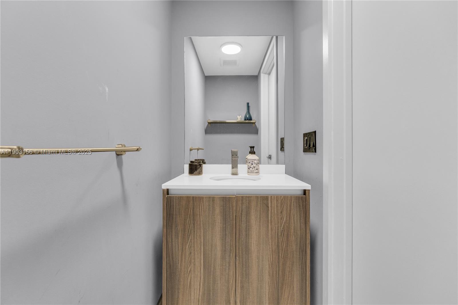 488 Northeast 18th Street, Unit 2104 Miami, FL 33132 - Photo 15 of 44 a bathroom with a sink a mirror and a toilet