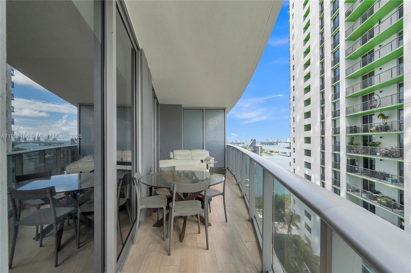 488 Northeast 18th Street, Unit 2104 Miami, FL 33132 - Photo 30 of 44 a balcony with table and chairs